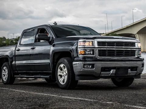 A Silverado towing a boat at the water